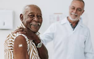 Smiling senior with bandage on shoulder
